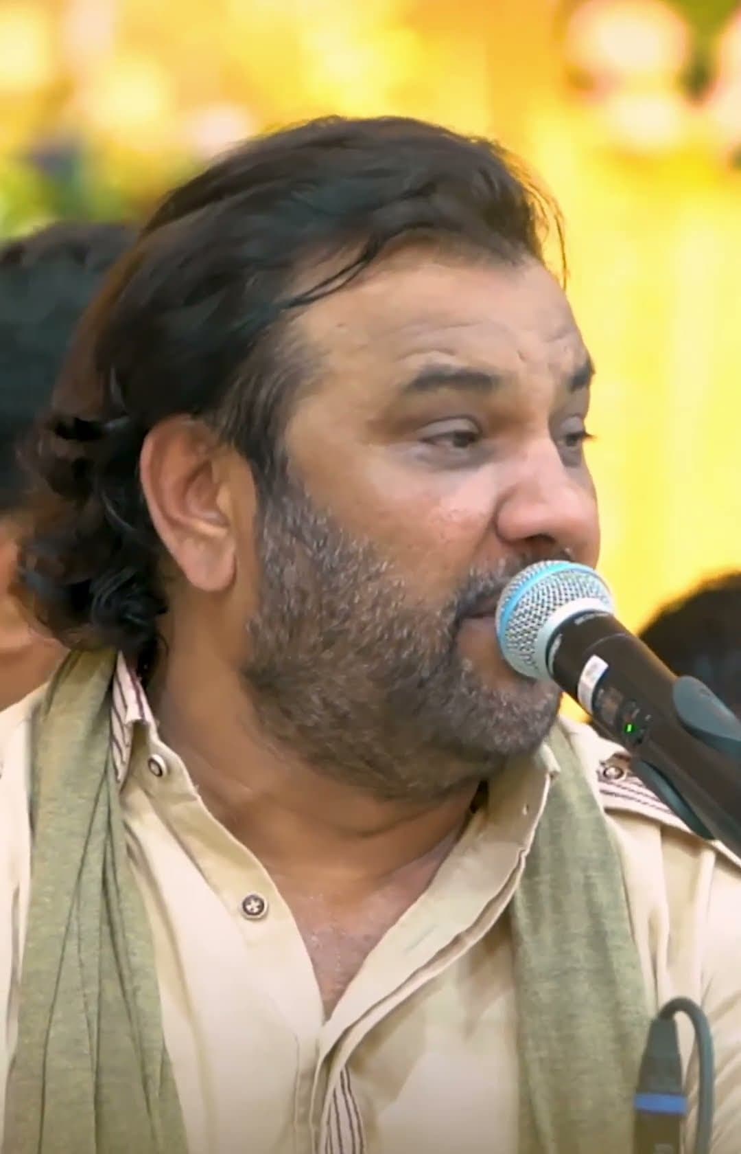 Close-up of Kirtidan Gadhvi singing at the microphone
